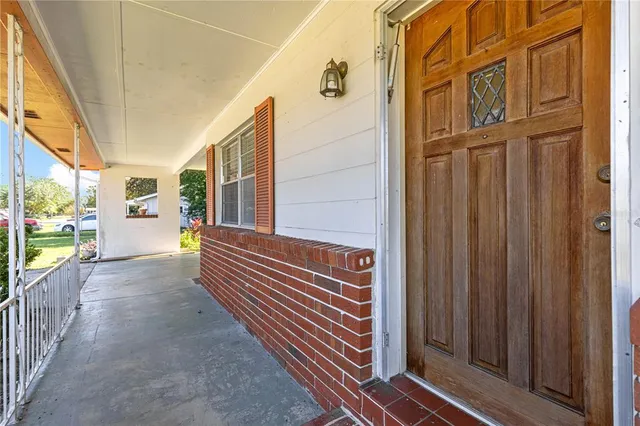 a view of a porch with wooden floor and stairs