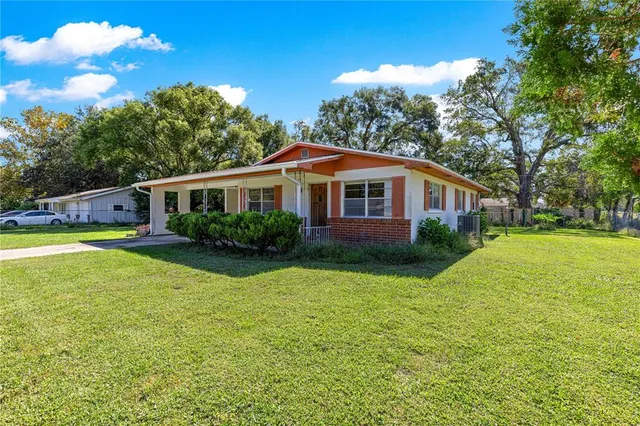 a house view with swimming pool and garden space
