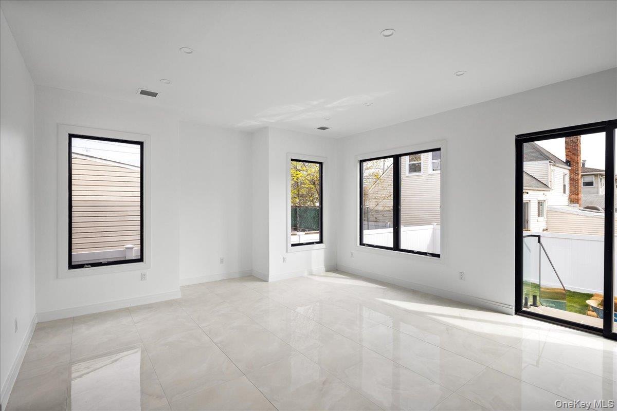 544 Arlington Road Cedarhurst, NY 11516 - Photo 18 of 38 a view of an empty room with a window