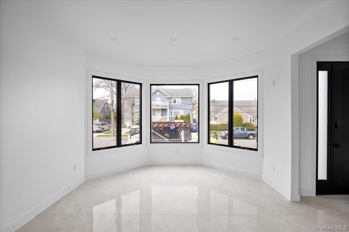 544 Arlington Road Cedarhurst, NY 11516 - Photo 19 of 38 an empty room with large windows and pool table