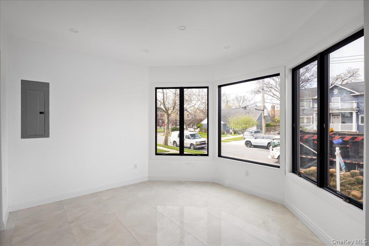 544 Arlington Road Cedarhurst, NY 11516 - Photo 20 of 38 an empty room with large windows