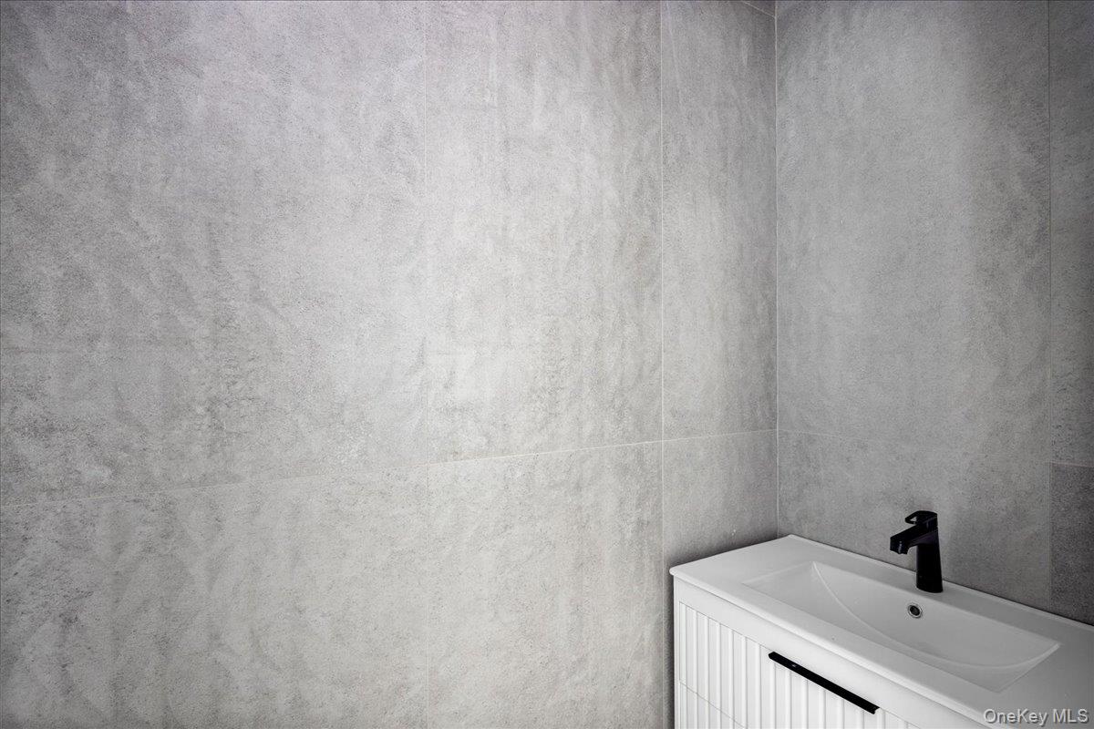 544 Arlington Road Cedarhurst, NY 11516 - Photo 21 of 38 a bathroom with a sink and vanity