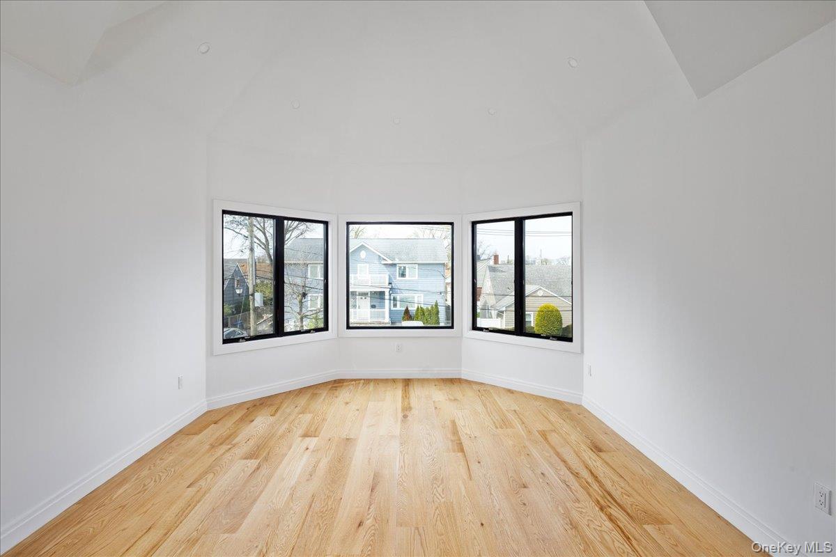 544 Arlington Road Cedarhurst, NY 11516 - Photo 24 of 38 wooden floor in an empty room with a window
