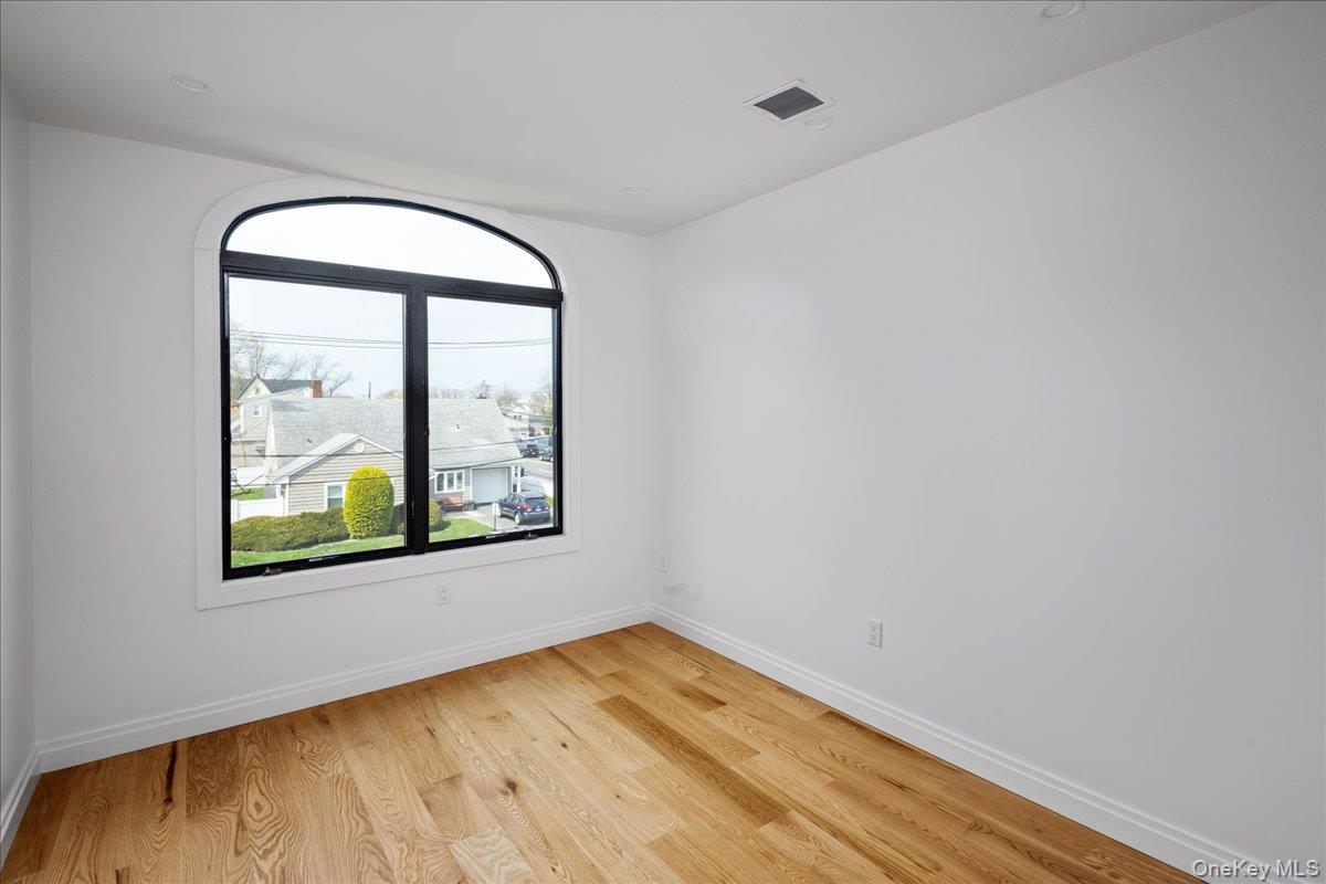 544 Arlington Road Cedarhurst, NY 11516 - Photo 31 of 38 an empty room with a window