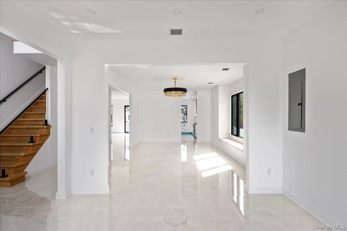 544 Arlington Road Cedarhurst, NY 11516 - Photo 7 of 38 a view of a hallway view with wooden floor and staircase