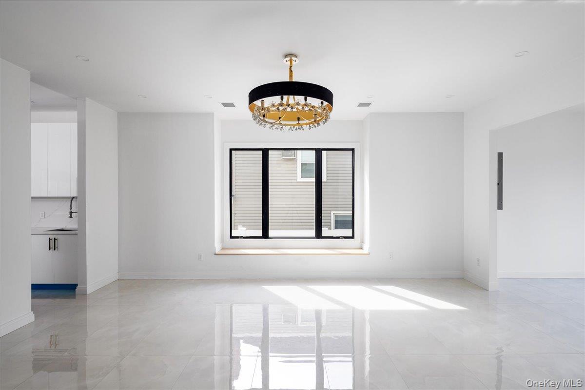 544 Arlington Road Cedarhurst, NY 11516 - Photo 9 of 38 a view of an empty room with a window