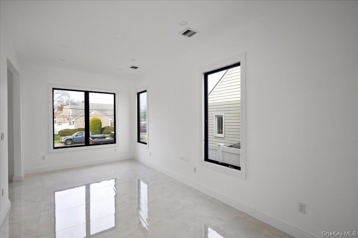 544 Arlington Road Cedarhurst, NY 11516 - Photo 10 of 38 a front view of a house with a large window