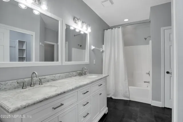 a bathroom with a sink double vanity and a mirror