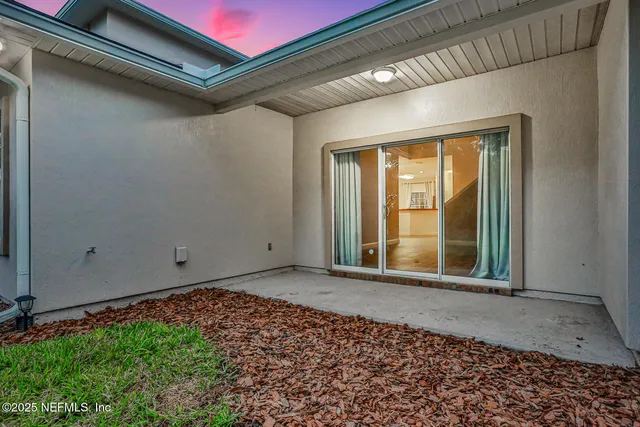 a house that has a big yard with wooden fence