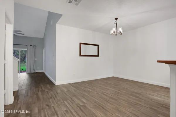 a view of a dining room with furniture wooden floor and a rug