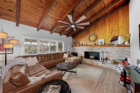 a living room with furniture a fireplace and a table