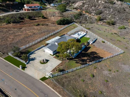 an aerial view of house with a yard