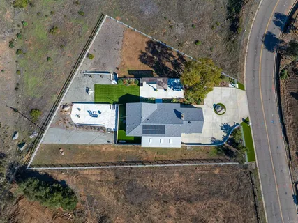 an aerial view of a house with a yard