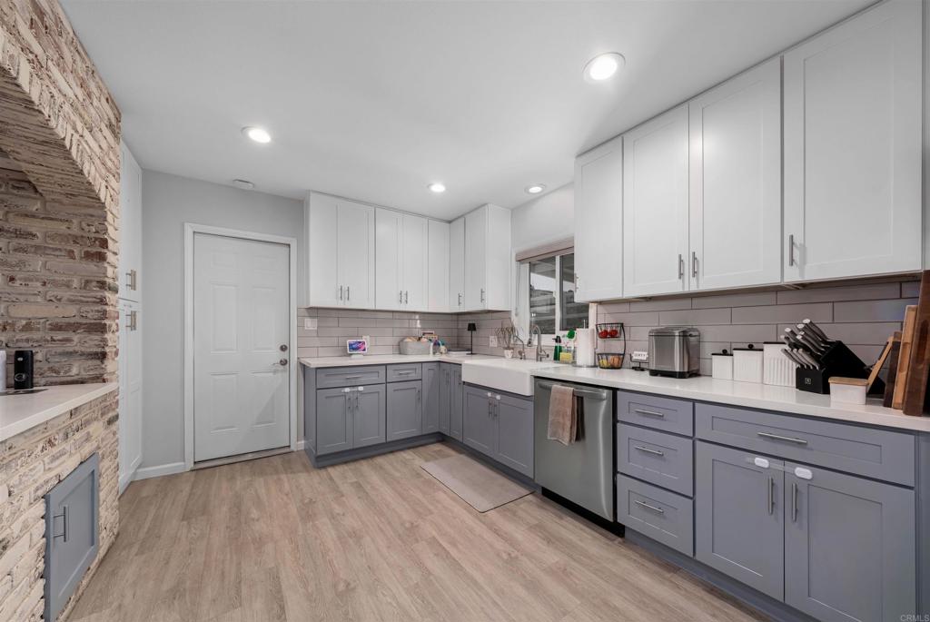 1358 Sundale Road El Cajon, CA 92019 - Photo 7 of 25 a kitchen with cabinets and wooden floor