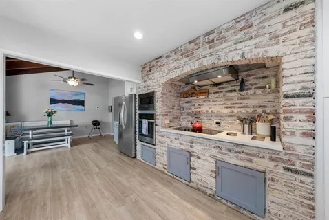 a kitchen with stainless steel appliances a stove and cabinets