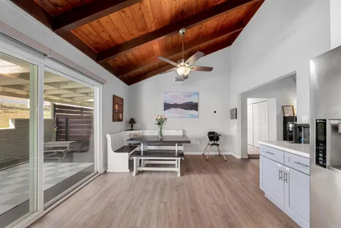 a view of a kitchen with wooden floor and electronic appliances