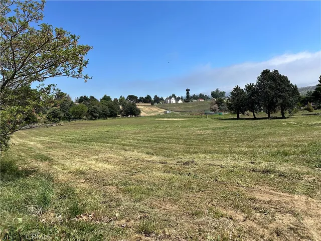 a view of a field with an ocean