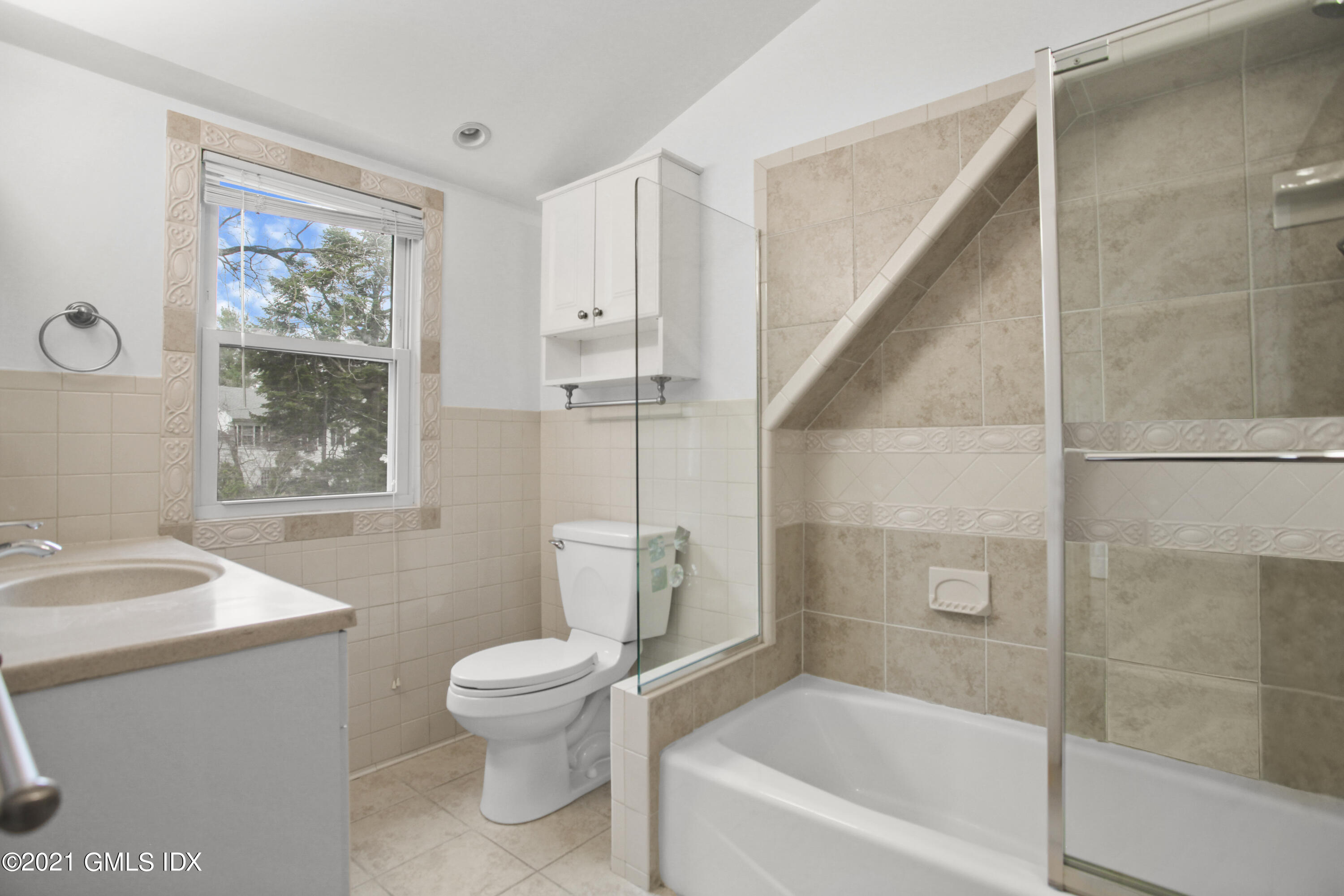 52 Bruce Park Drive, Unit B Greenwich, CT 06830 - Photo 11 of 20 a bathroom with a bathtub shower sink vanity mirror and toilet