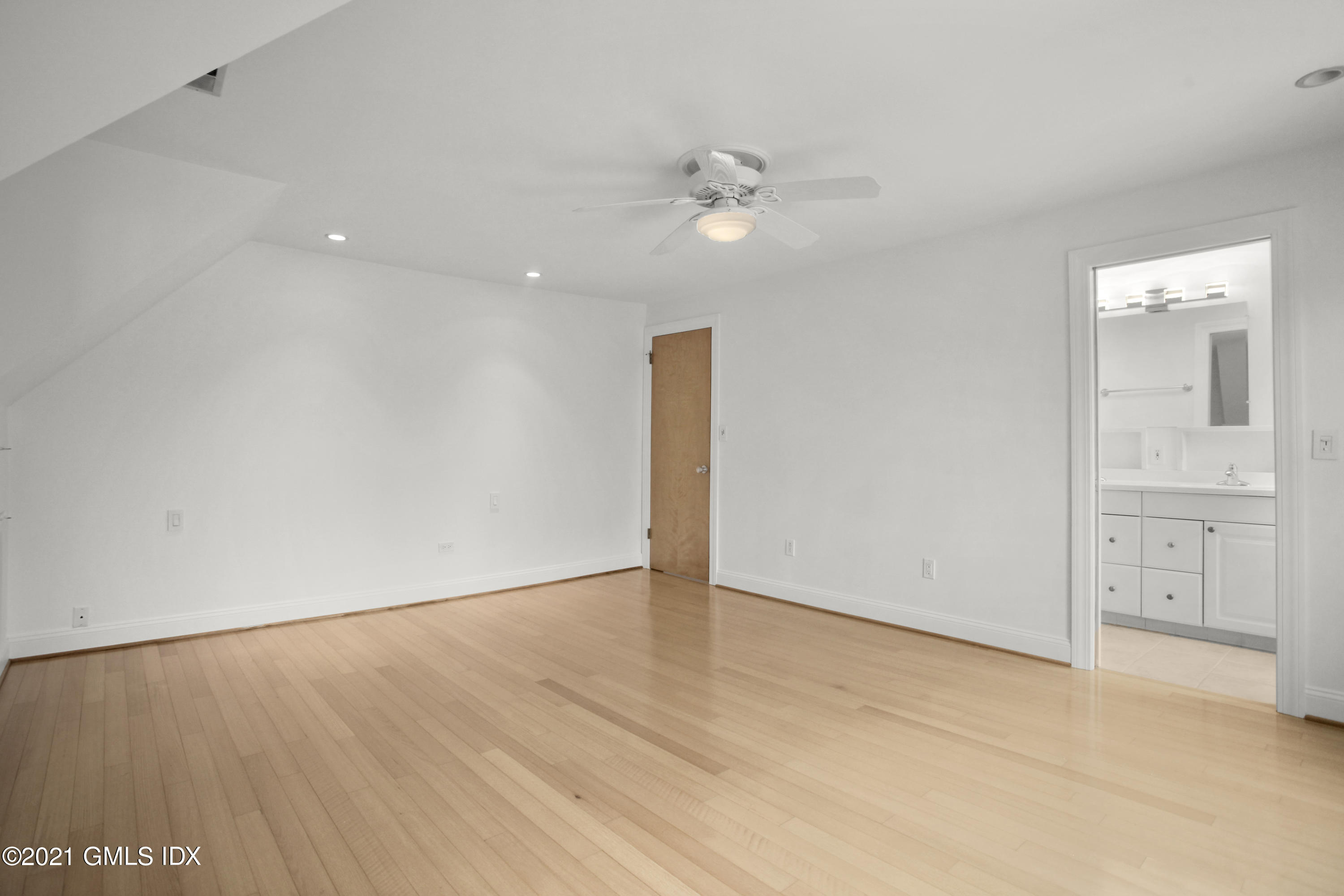 52 Bruce Park Drive, Unit B Greenwich, CT 06830 - Photo 14 of 20 wooden floor in an empty room with a window