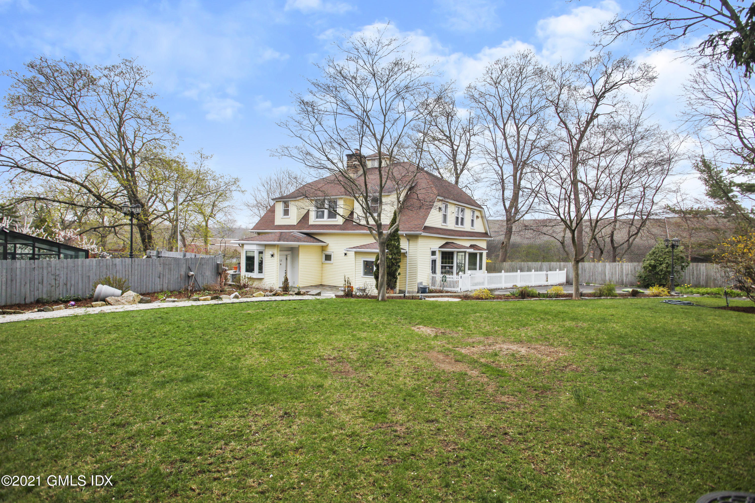 52 Bruce Park Drive, Unit B Greenwich, CT 06830 - Photo 20 of 20 a front view of house with yard and green space