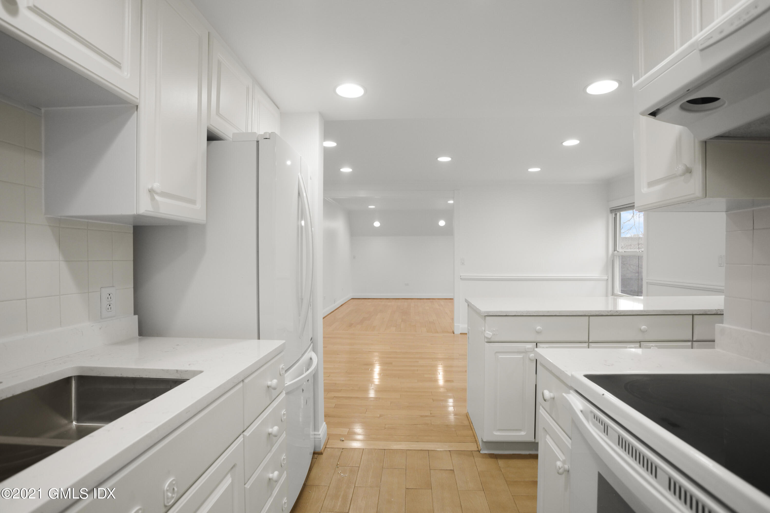 52 Bruce Park Drive, Unit B Greenwich, CT 06830 - Photo 6 of 20 a kitchen with a sink and cabinets