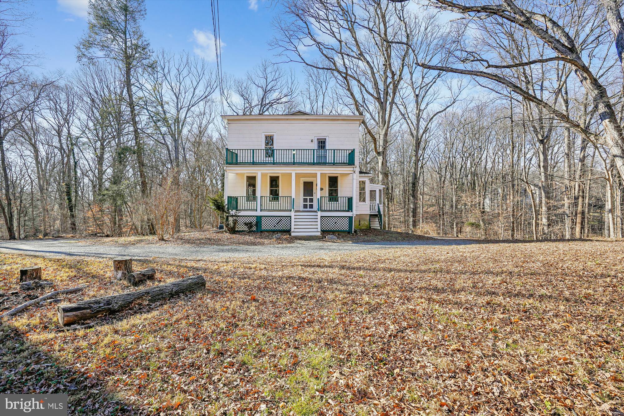 a view of residential houses with snow on the road