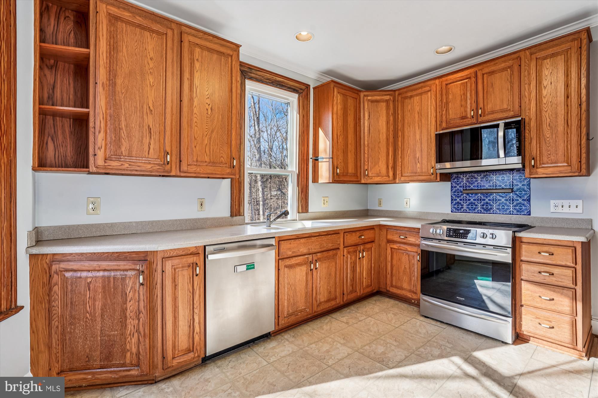 2799 Beechbank Road Silver Spring, MD 20910 - Photo 14 of 42 a kitchen with stainless steel appliances granite countertop a stove a sink and a microwave