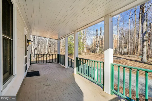 a view of a porch with wooden floor and outdoor space