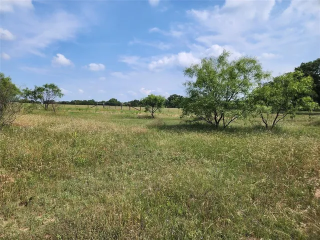 a view of a lake with houses in the back