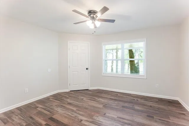 wooden floor in an empty room with a window