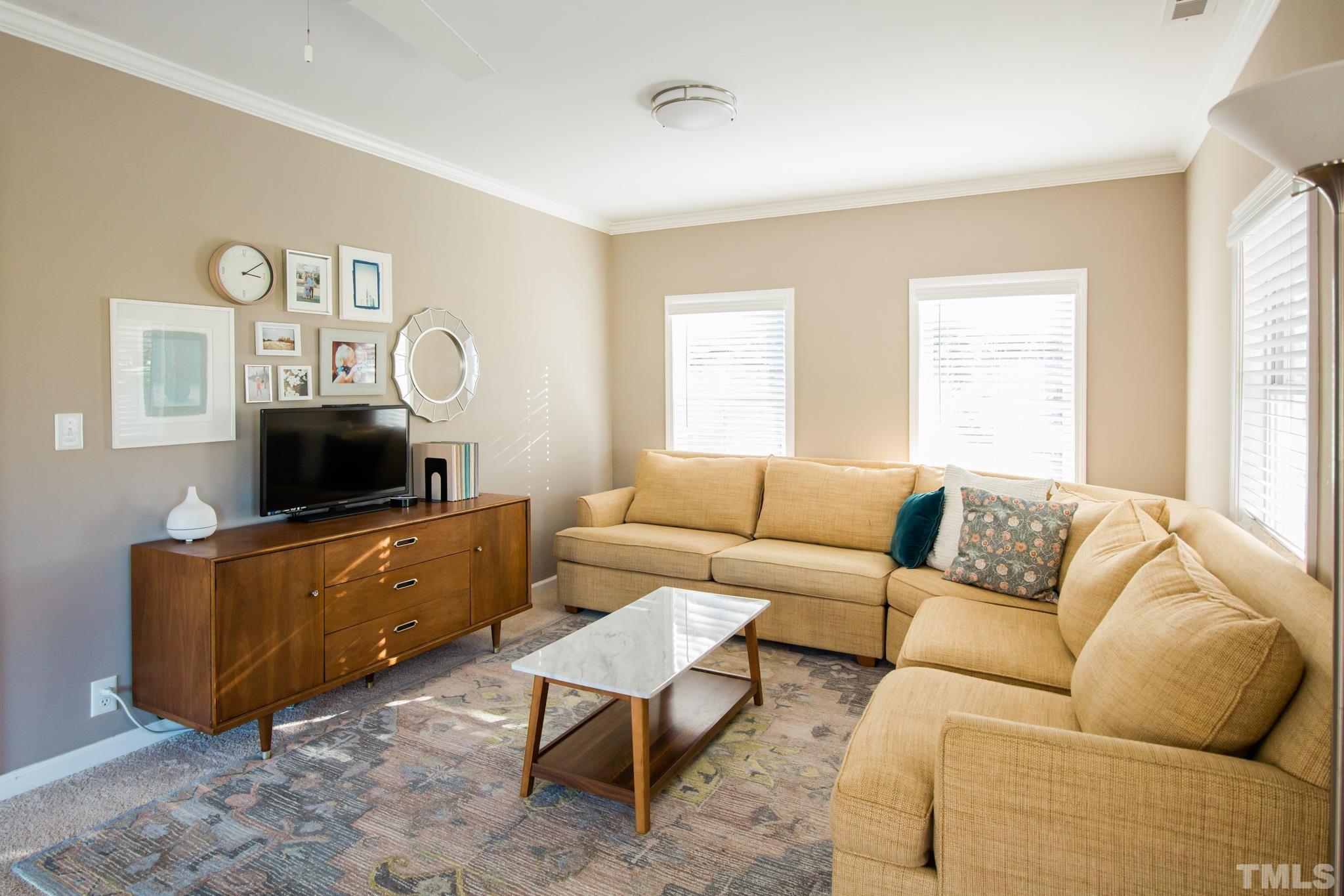 623 Little Creek Church Road Clayton, NC 27520 - Photo 20 of 47 a living room with furniture and a flat screen tv