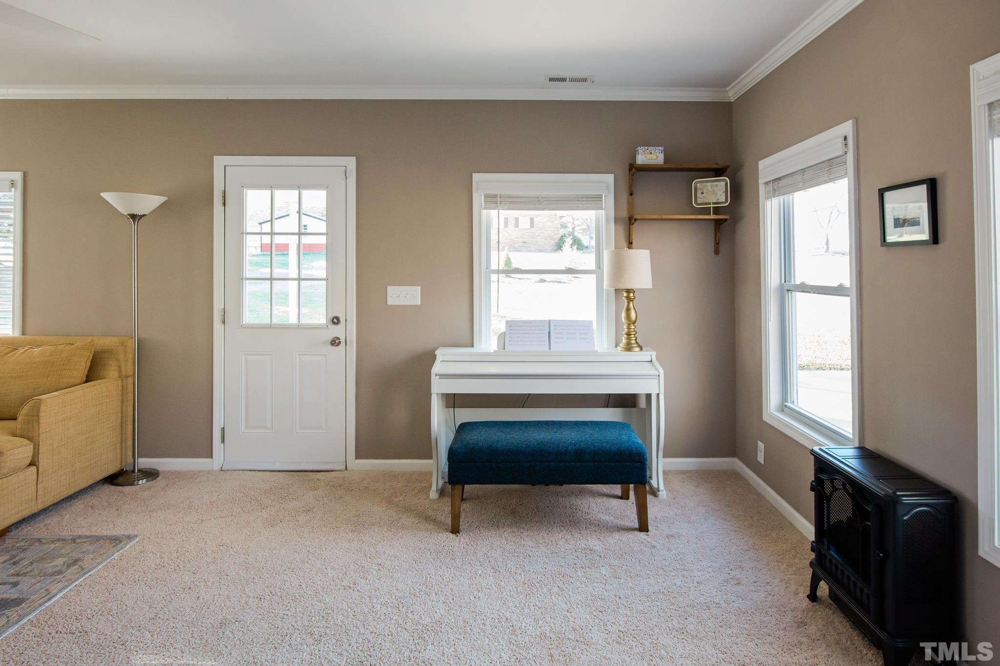 623 Little Creek Church Road Clayton, NC 27520 - Photo 21 of 47 a bedroom with furniture and a window