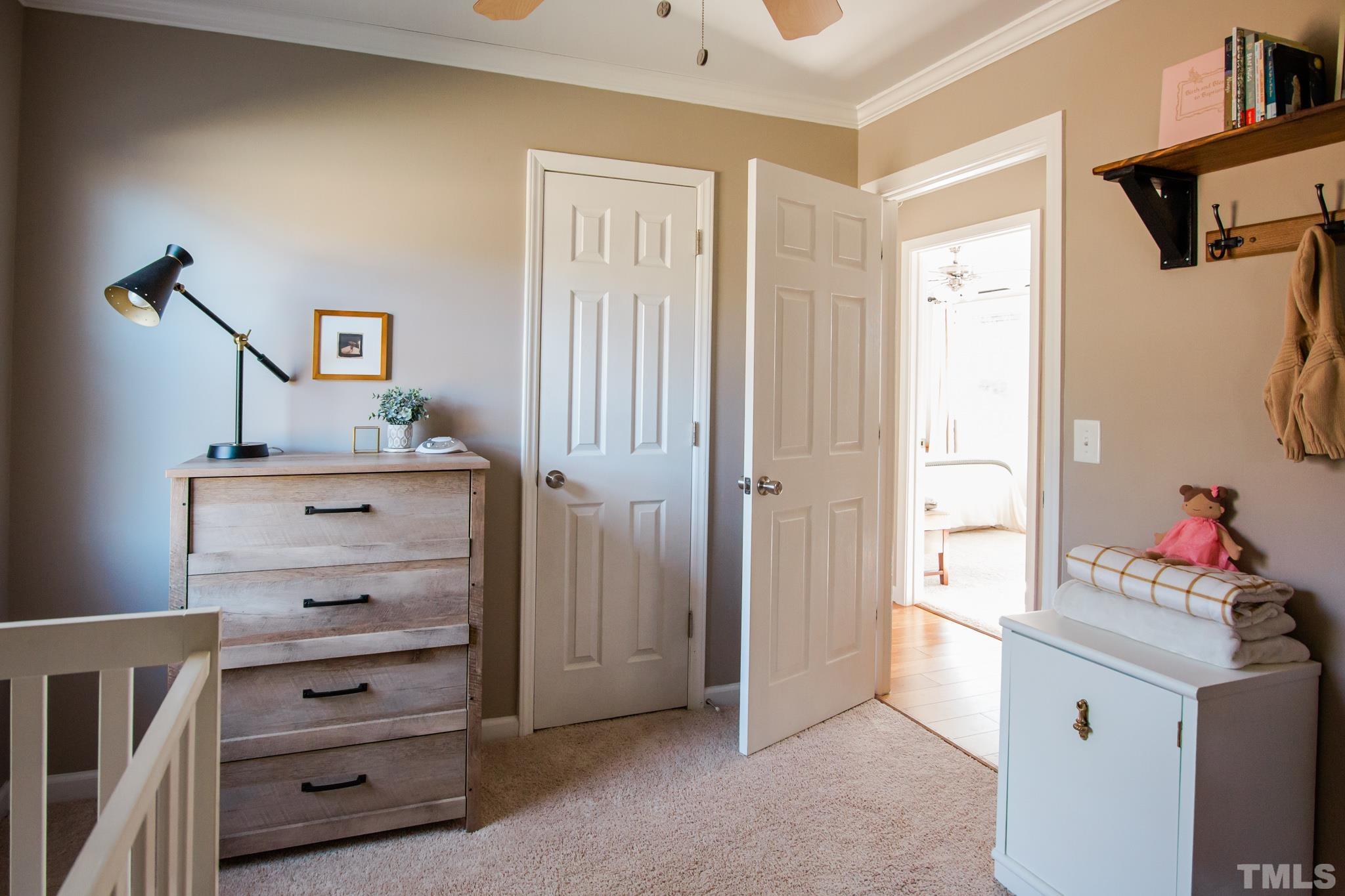 623 Little Creek Church Road Clayton, NC 27520 - Photo 24 of 47 a view of a bedroom with baby crib and cabinet