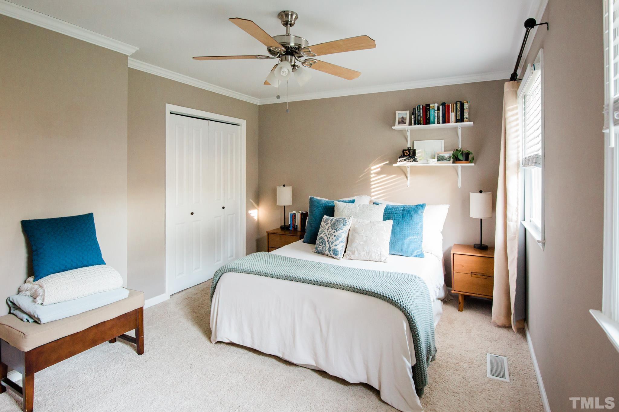 623 Little Creek Church Road Clayton, NC 27520 - Photo 30 of 47 a bedroom with a bed and a lamp