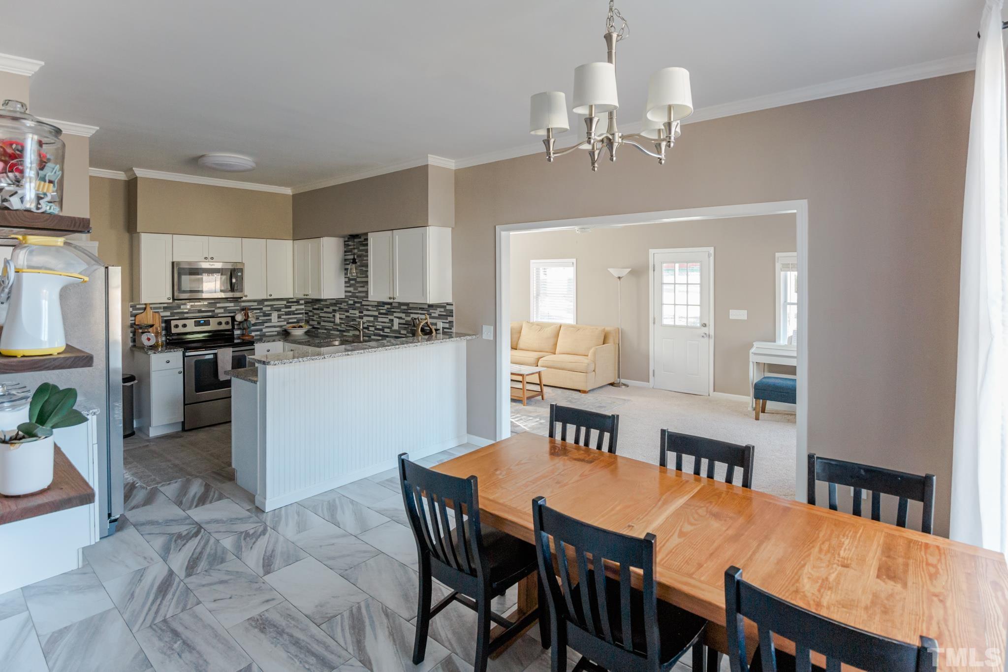 623 Little Creek Church Road Clayton, NC 27520 - Photo 3 of 47 a view of a dining room with furniture and wooden floor