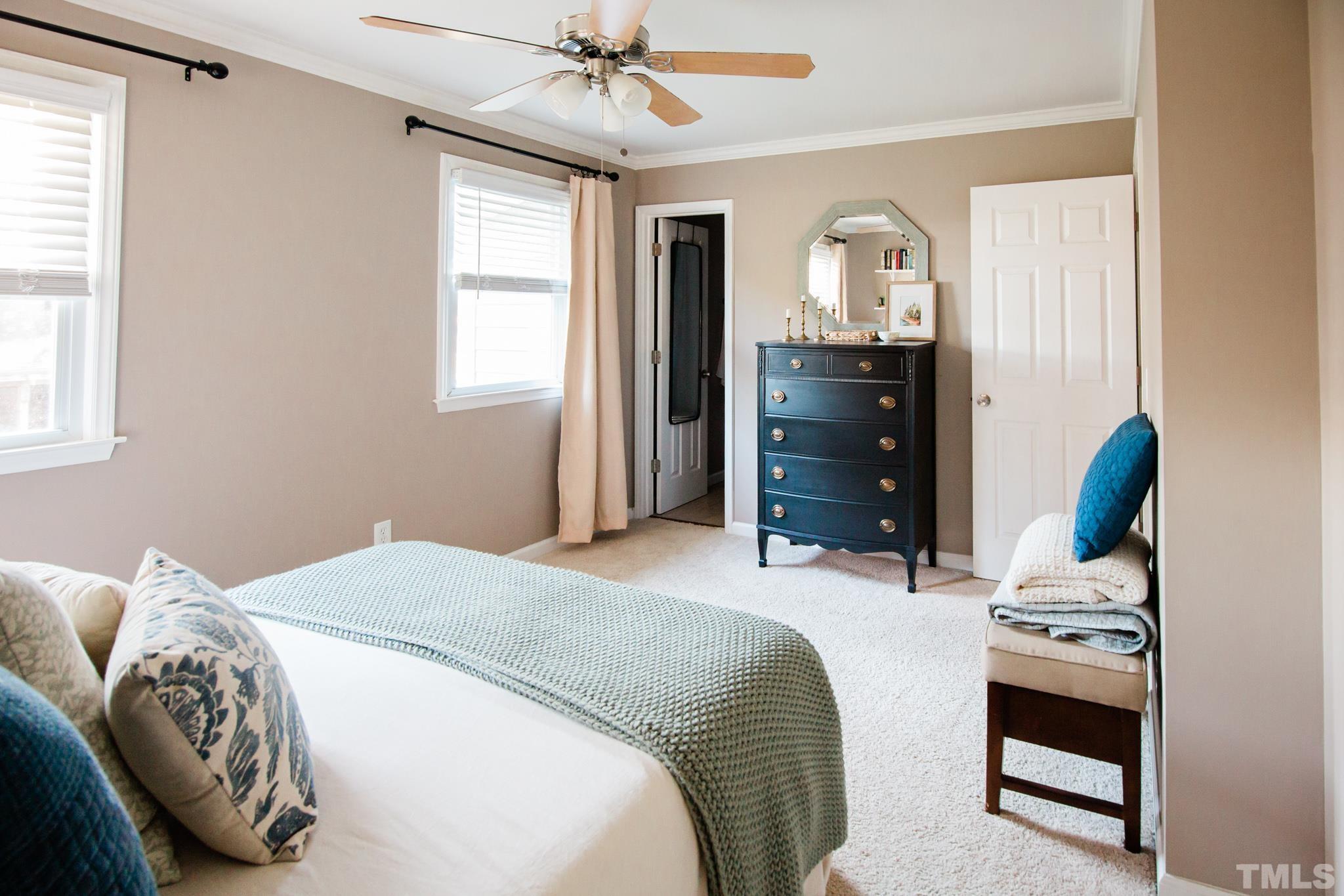 623 Little Creek Church Road Clayton, NC 27520 - Photo 31 of 47 a bedroom with a bed and a chandelier