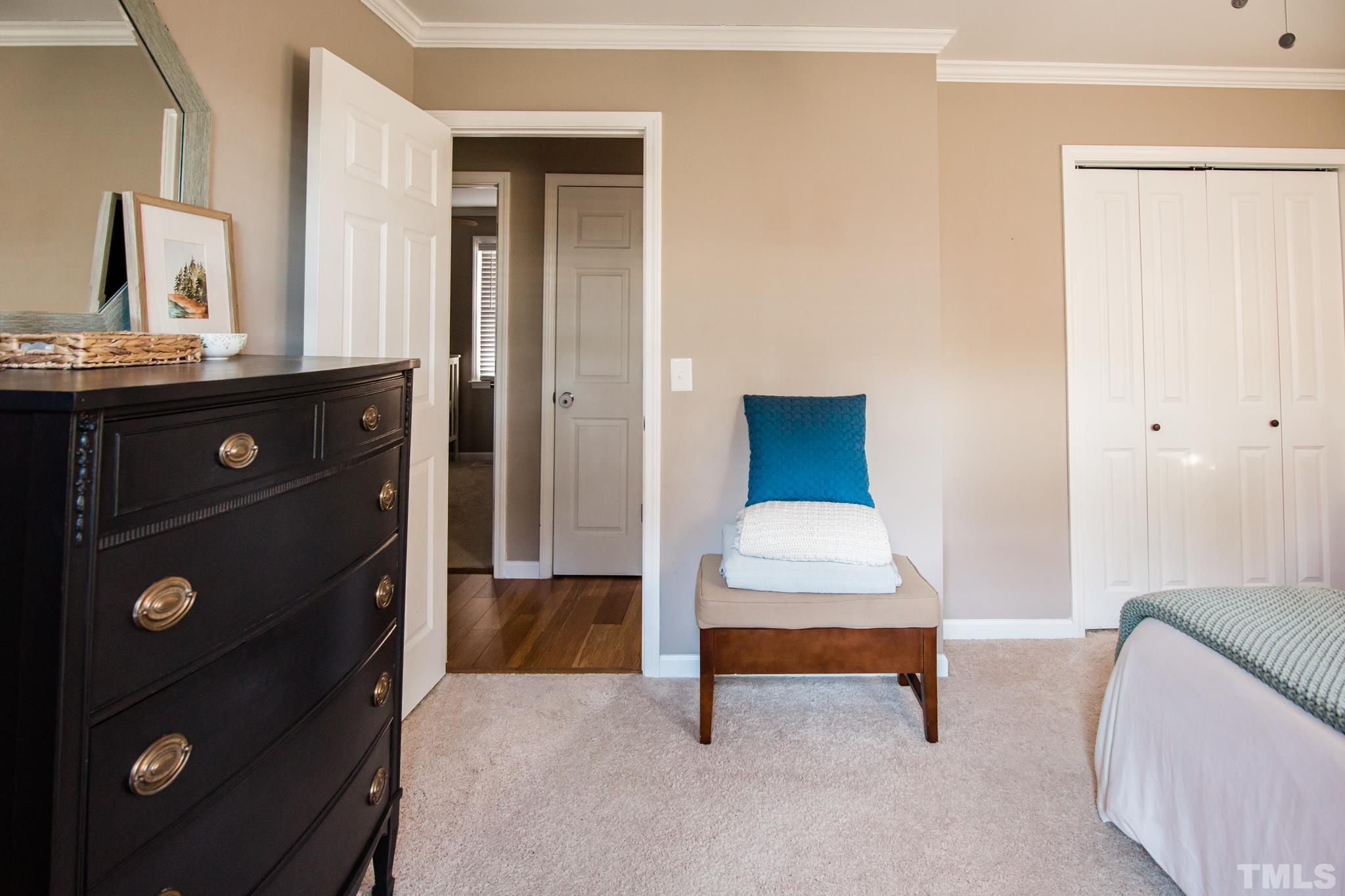623 Little Creek Church Road Clayton, NC 27520 - Photo 32 of 47 a bedroom with a bed and a lamp on dresser
