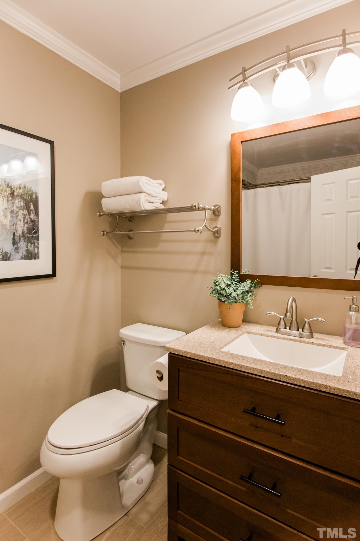 623 Little Creek Church Road Clayton, NC 27520 - Photo 41 of 47 a bathroom with a granite countertop toilet sink and mirror