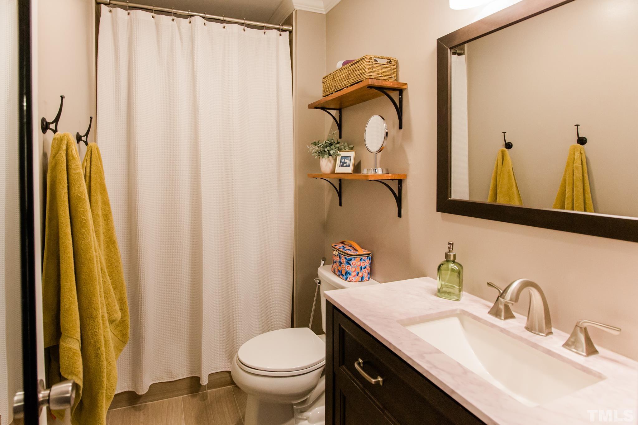 623 Little Creek Church Road Clayton, NC 27520 - Photo 43 of 47 a bathroom with a granite countertop sink and a mirror