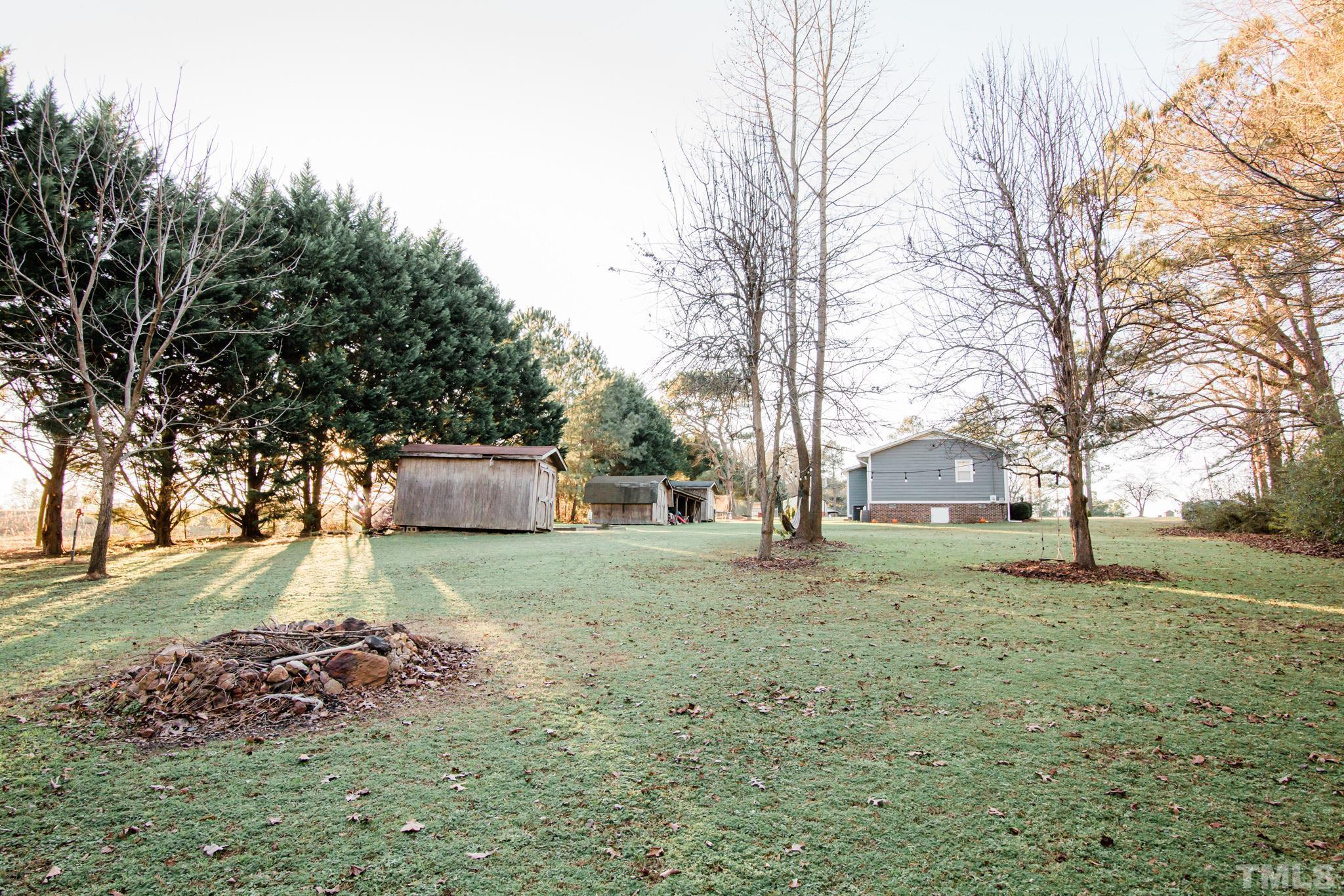 623 Little Creek Church Road Clayton, NC 27520 - Photo 45 of 47 a backyard of a house with lots of green space