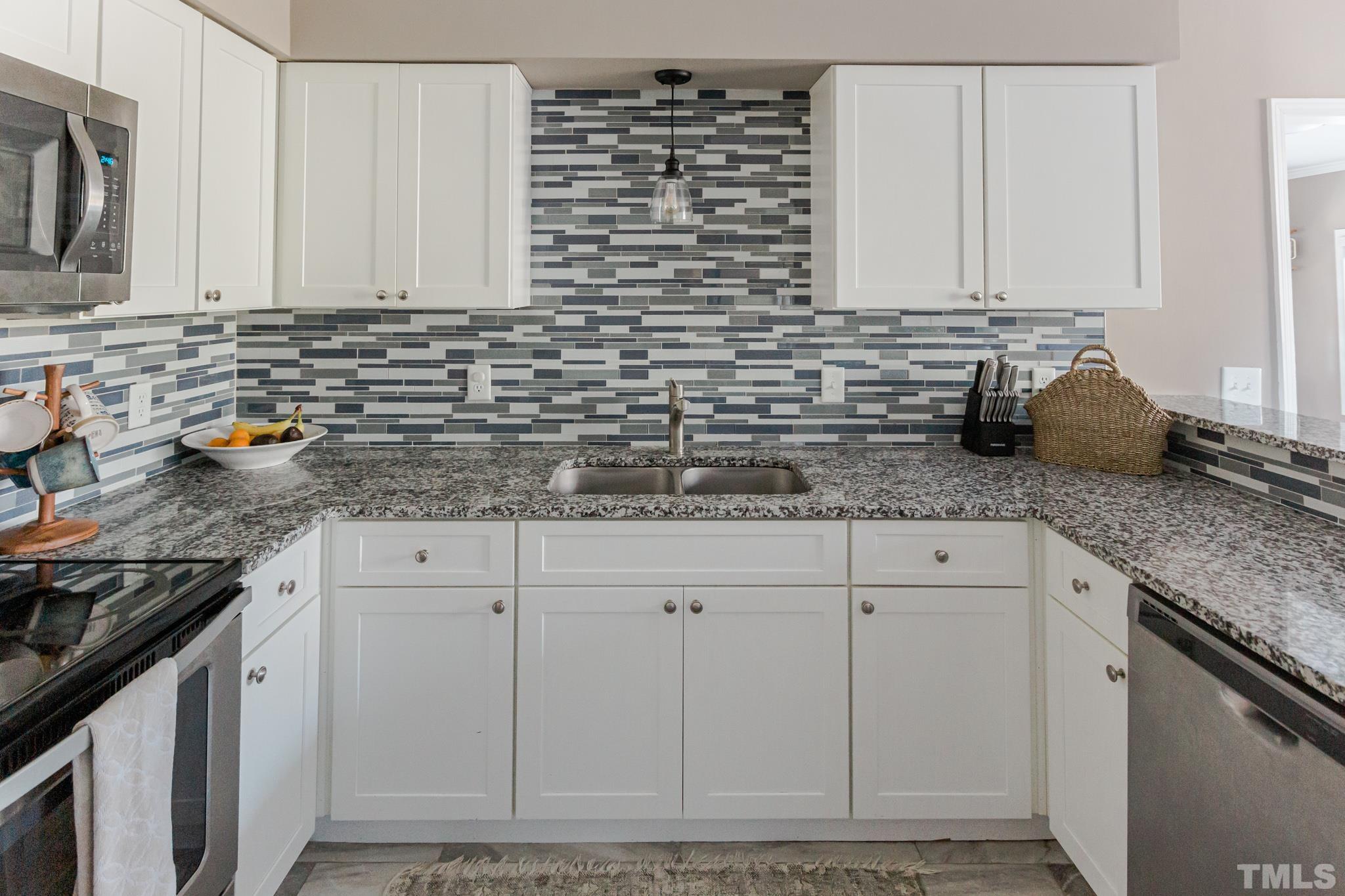 623 Little Creek Church Road Clayton, NC 27520 - Photo 6 of 47 a kitchen with granite countertop cabinets and white appliances