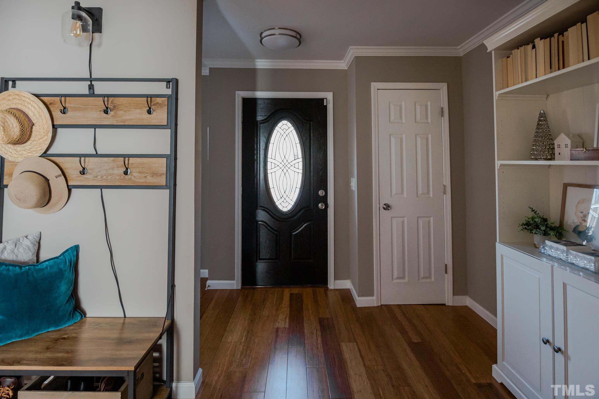 623 Little Creek Church Road Clayton, NC 27520 - Photo 9 of 47 a view of a hallway with wooden floor windows and entryway