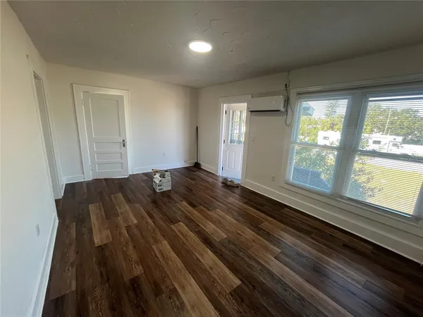 a view of a room with wooden floor