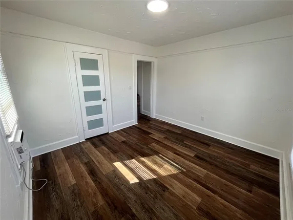 a view of room with wooden floor