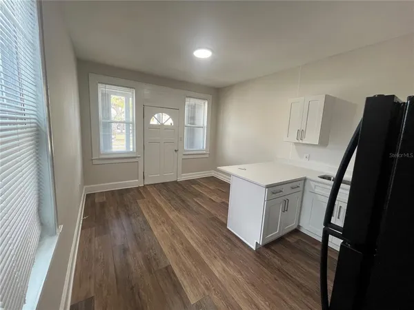 a kitchen with a refrigerator and a stove