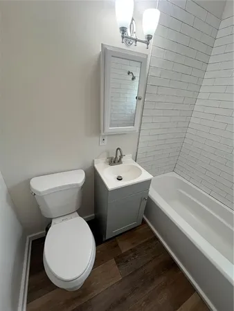 a bathroom with a toilet a sink and bathtub