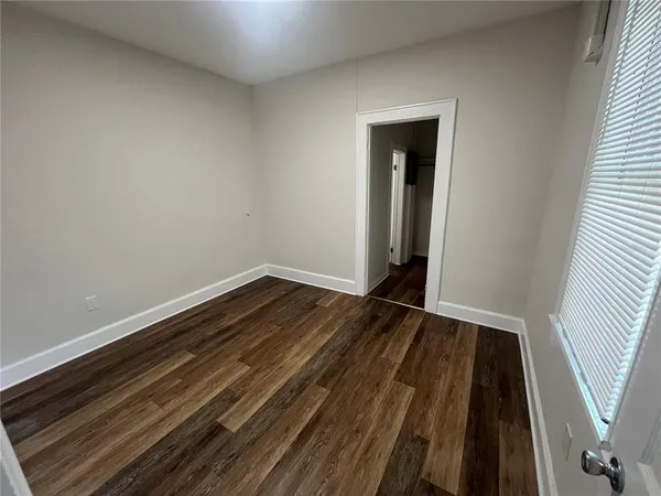 an empty room with wooden floor