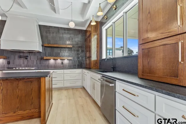 a kitchen with granite countertop white cabinets and white appliances