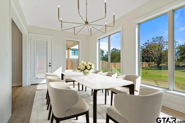 a view of a dining room with furniture wooden floor and chandelier