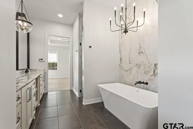 a bathroom with a bathtub a sink and a shower